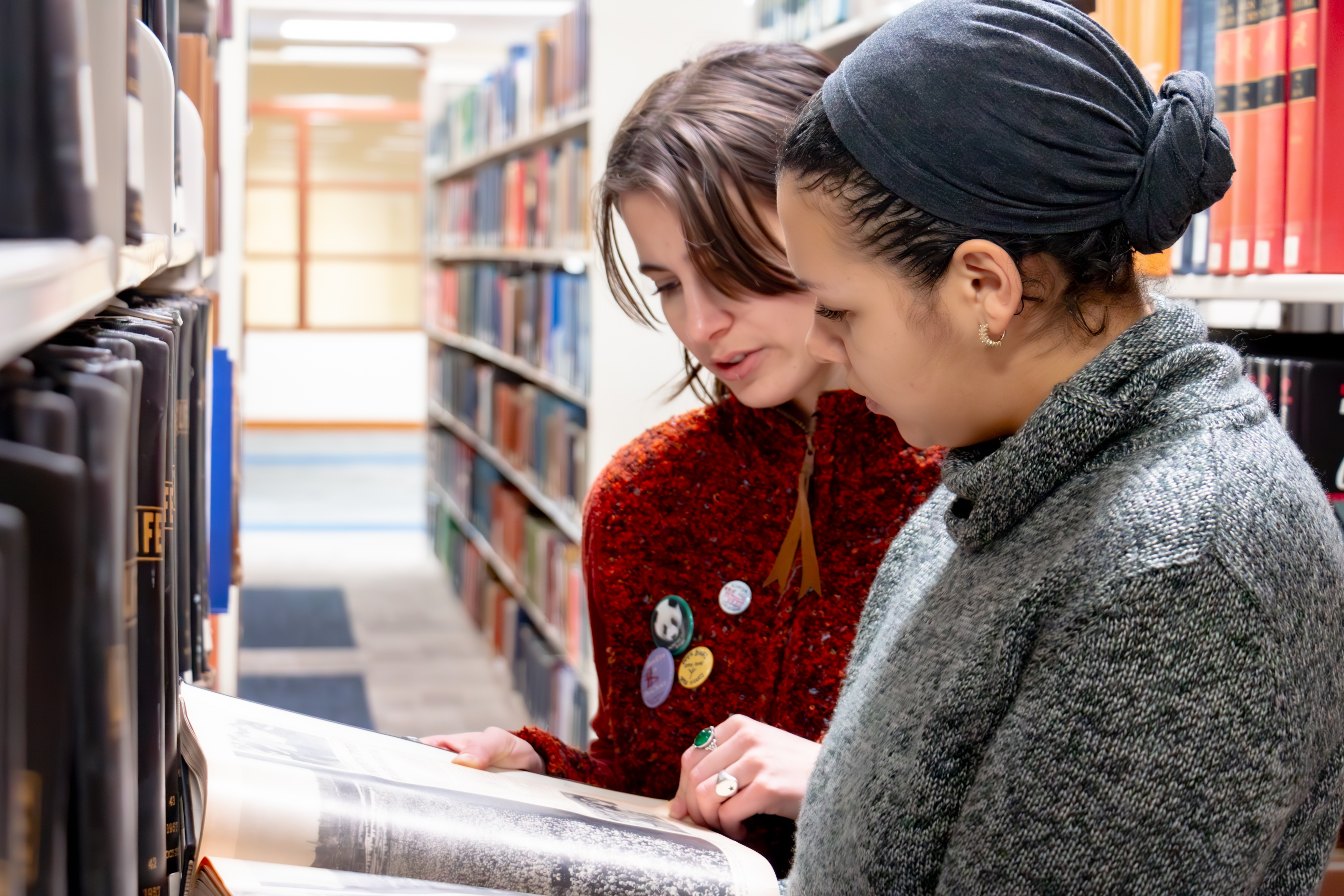 Bella and Fiona look at a library book